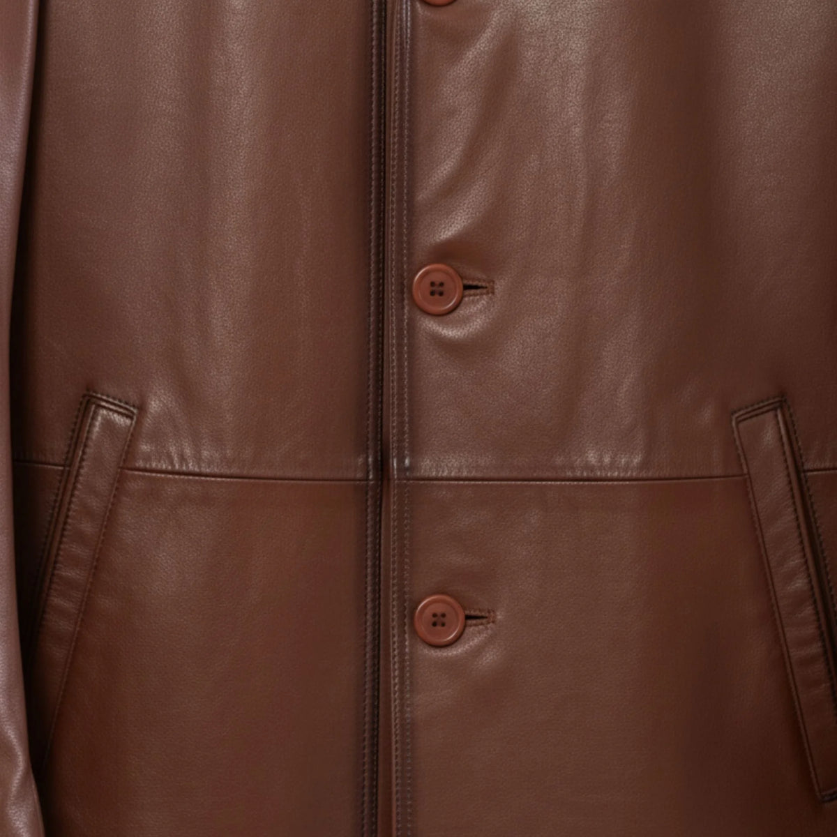 Button front and welt pockets on men’s brown leather blazer jacket