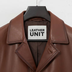 Close up of lapel collar and Leather Unit label on brown leather blazer