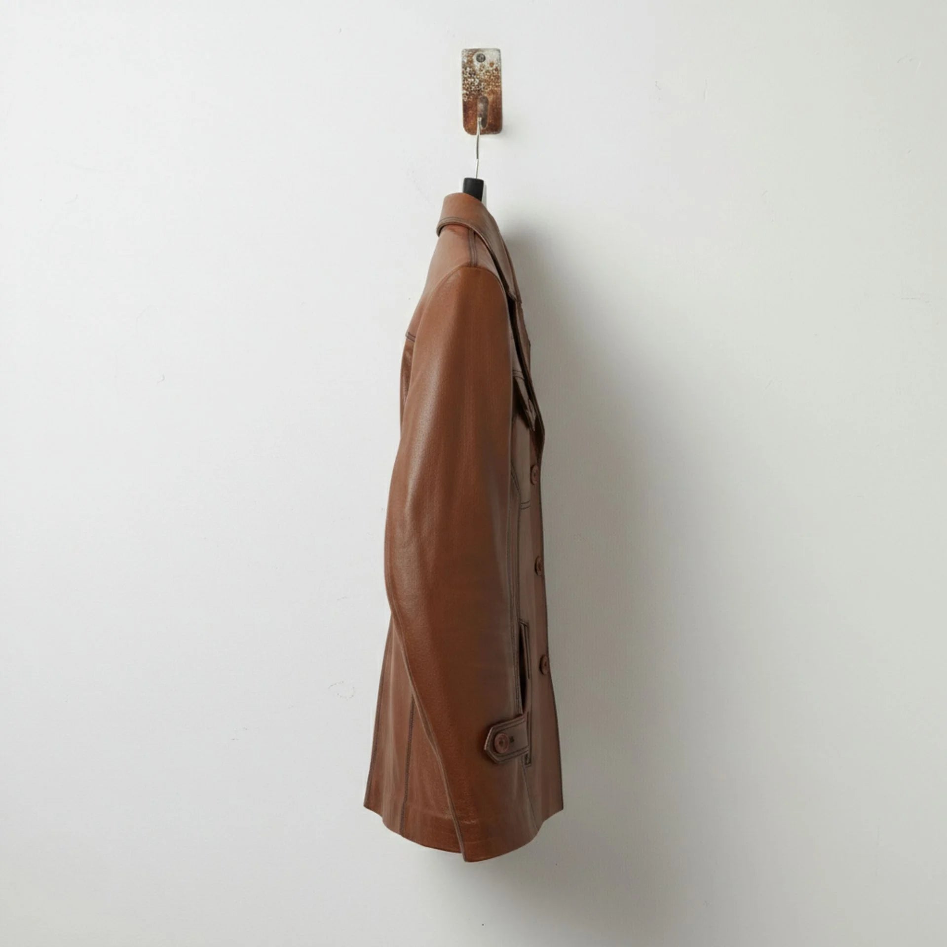 side profile of men's brown leather coat with button front