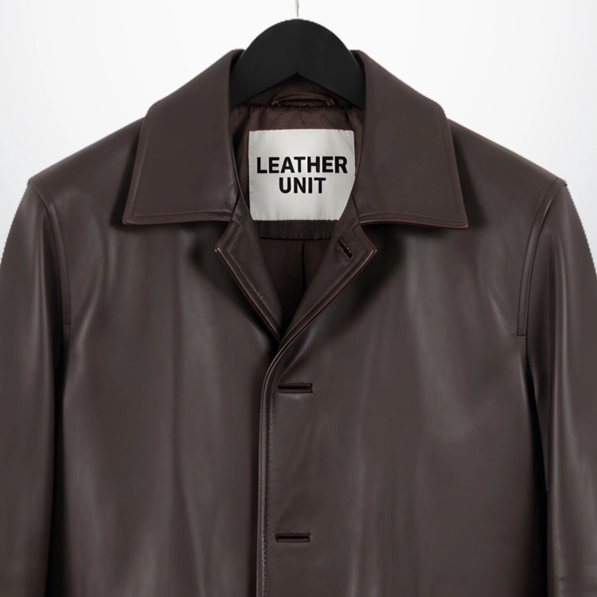 Close up of collar and covered button placket on men's brown leather car coat.