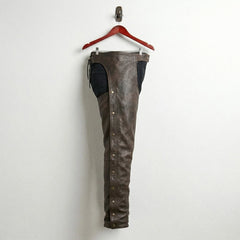 Side profile of men's brown leather chaps with snap leg closures
