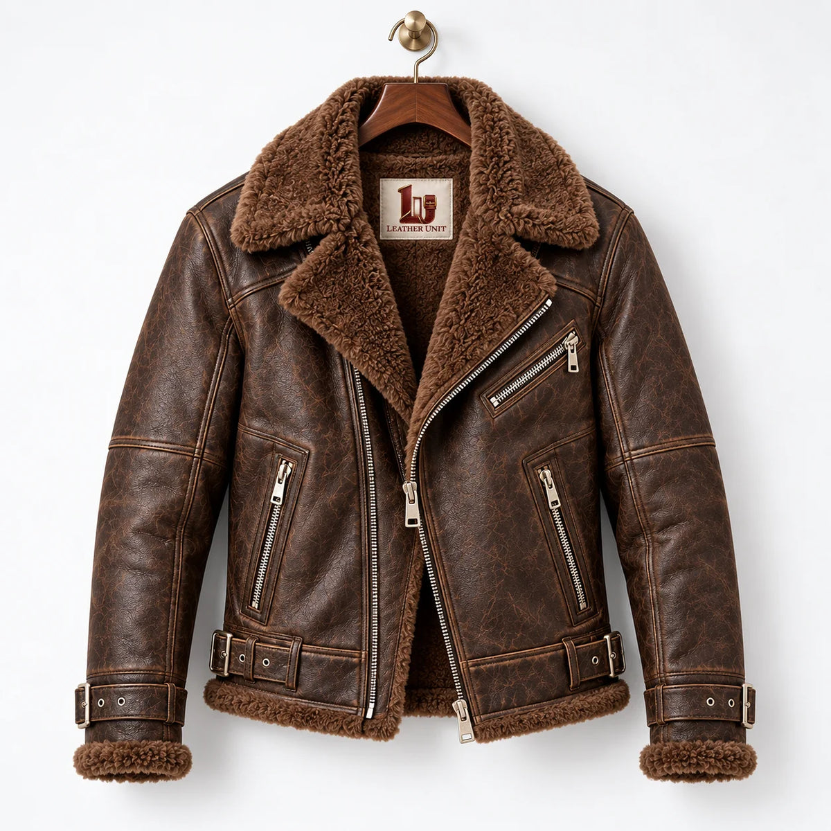 Front hanger view of brown sheepskin aviator jacket with wide faux fur collar, asymmetric metal zip and pockets