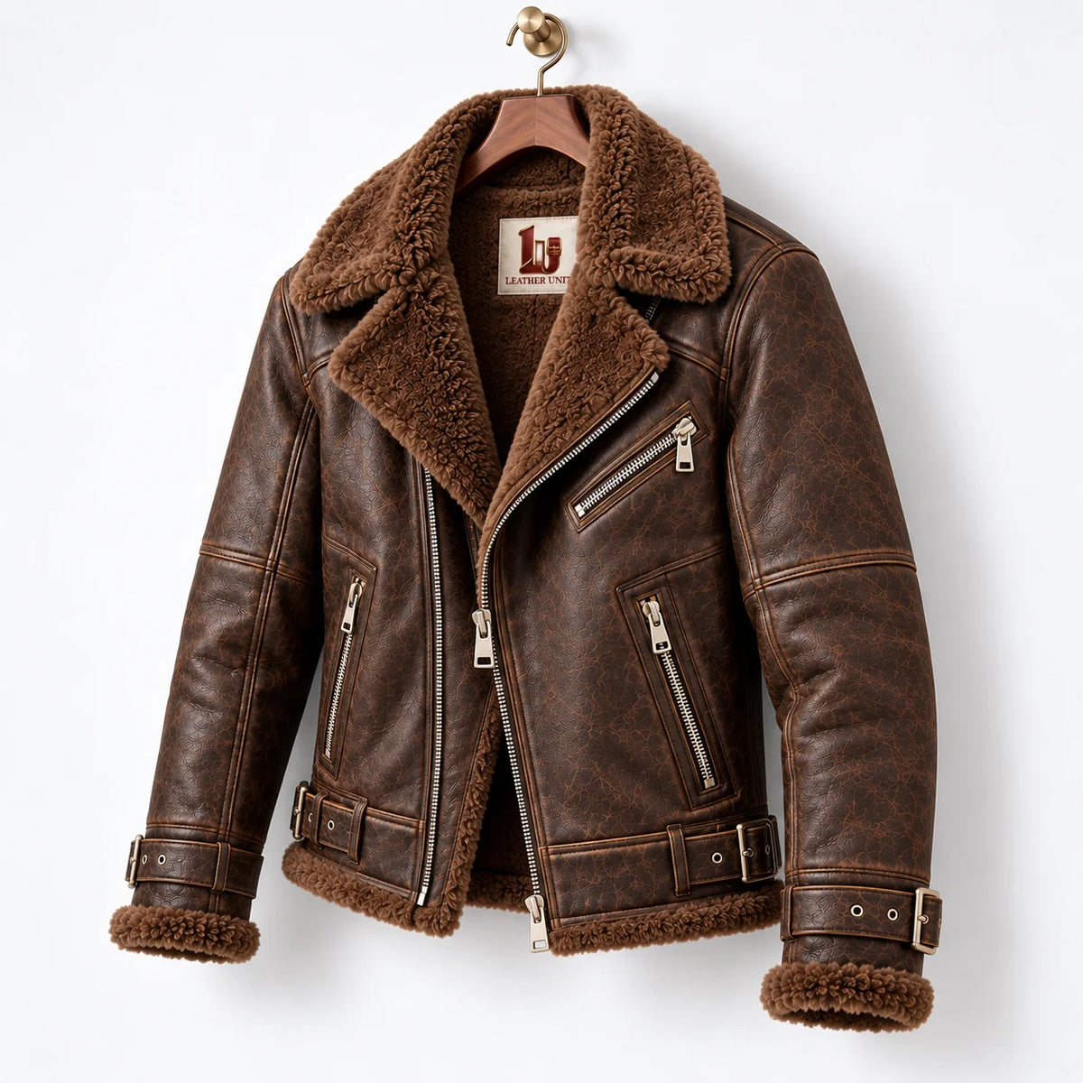 Three-quarter hanger view of espresso brown leather aviator jacket with faux fur interior and metal zip details