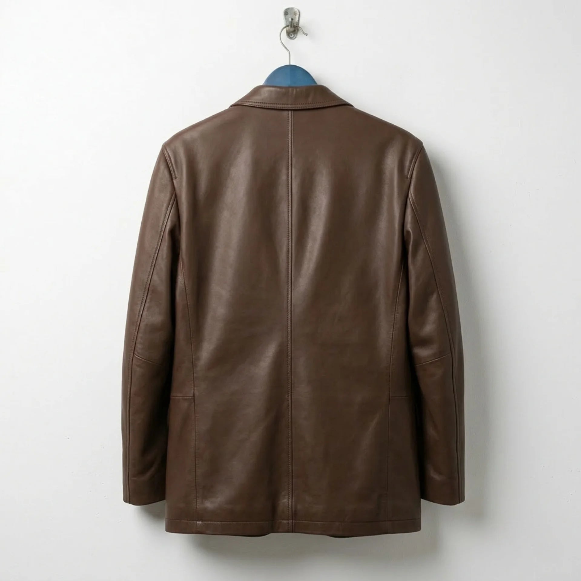 Back view of men’s brown leather blazer jacket showing clean seams