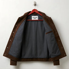 Interior of men's brown suede jacket showing grey lining and inside pocket.