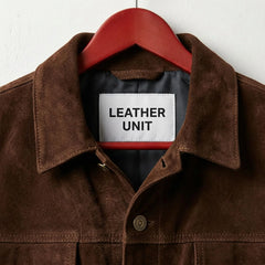 Close up of collar and Leather Unit label on men's brown suede jacket.