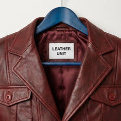 Close up of notch lapel and Leather Unit label on burgundy leather blazer