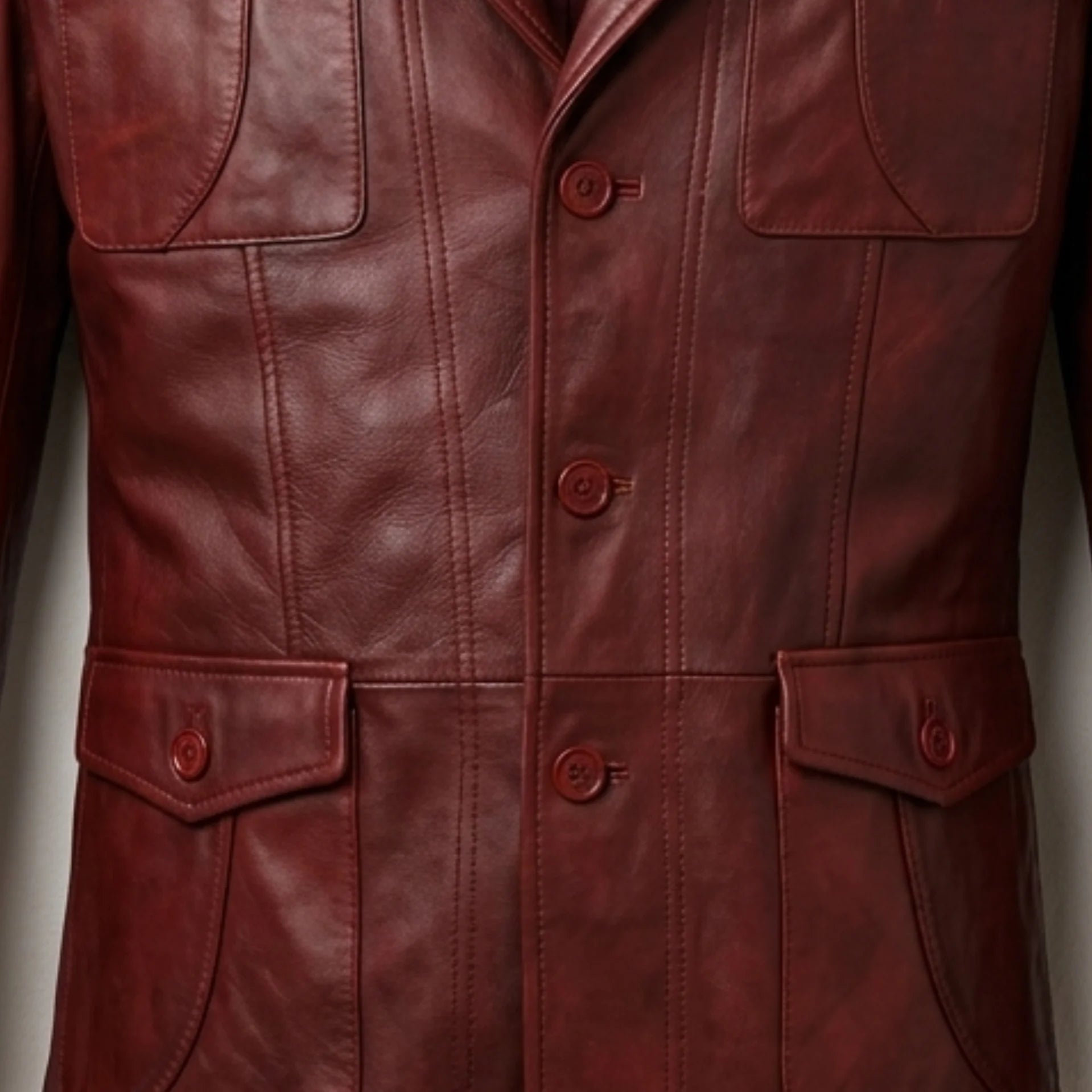 Front buttons and flap pocket detail on men’s burgundy leather blazer jacket