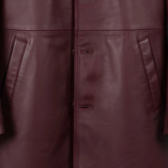 Front button placket and pocket detail on men’s burgundy leather jacket