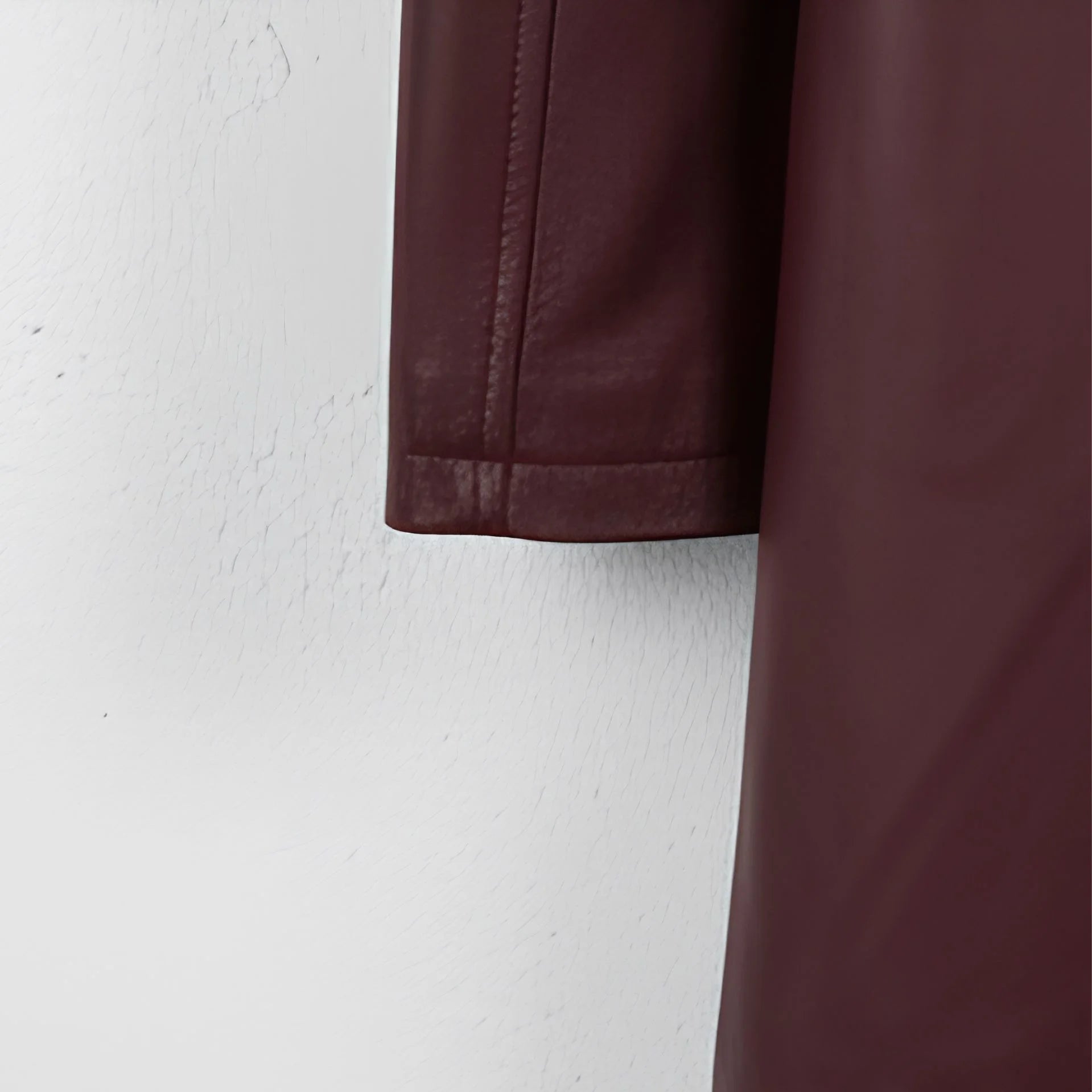 Sleeve hem detail on men’s maroon leather coat
