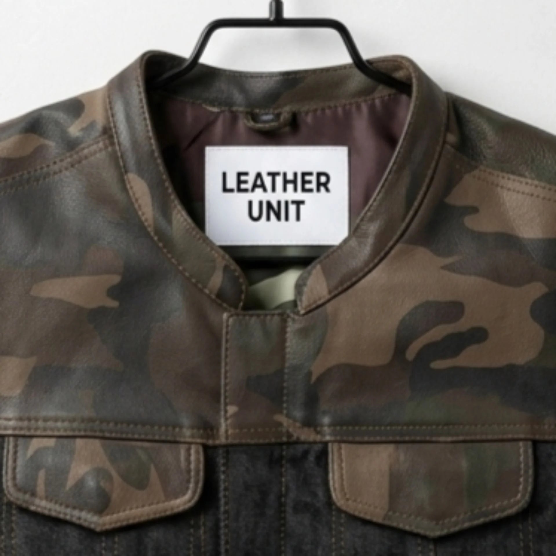 Close-up of collar and Leather Unit label on men's camo leather vest