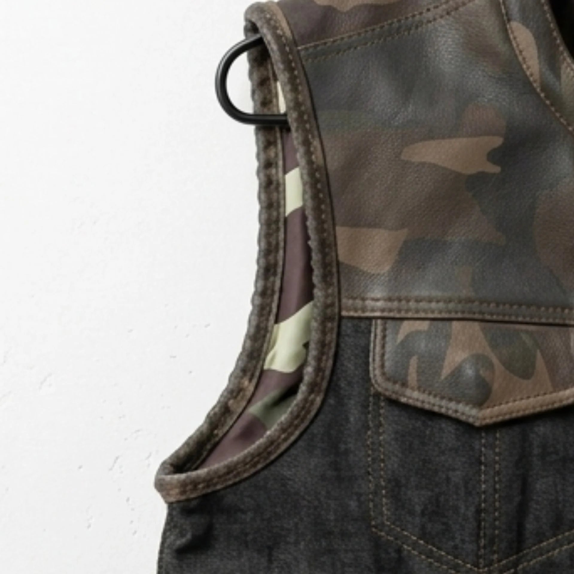 Detail of camo leather shoulder and armhole trim on infantry style vest