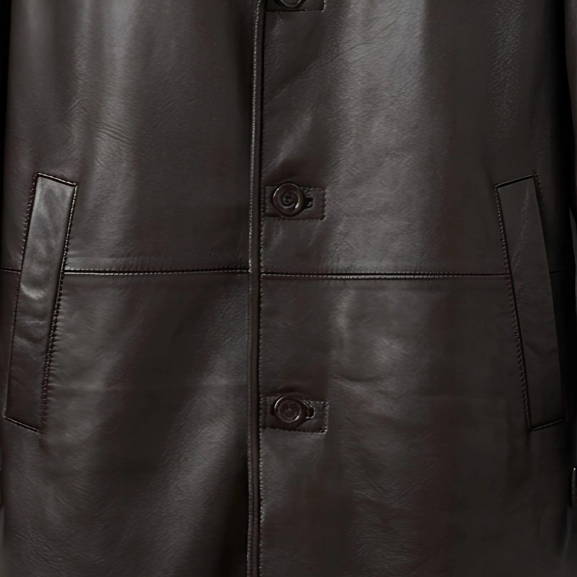 Button front and welt pockets on men’s dark brown shearling coat