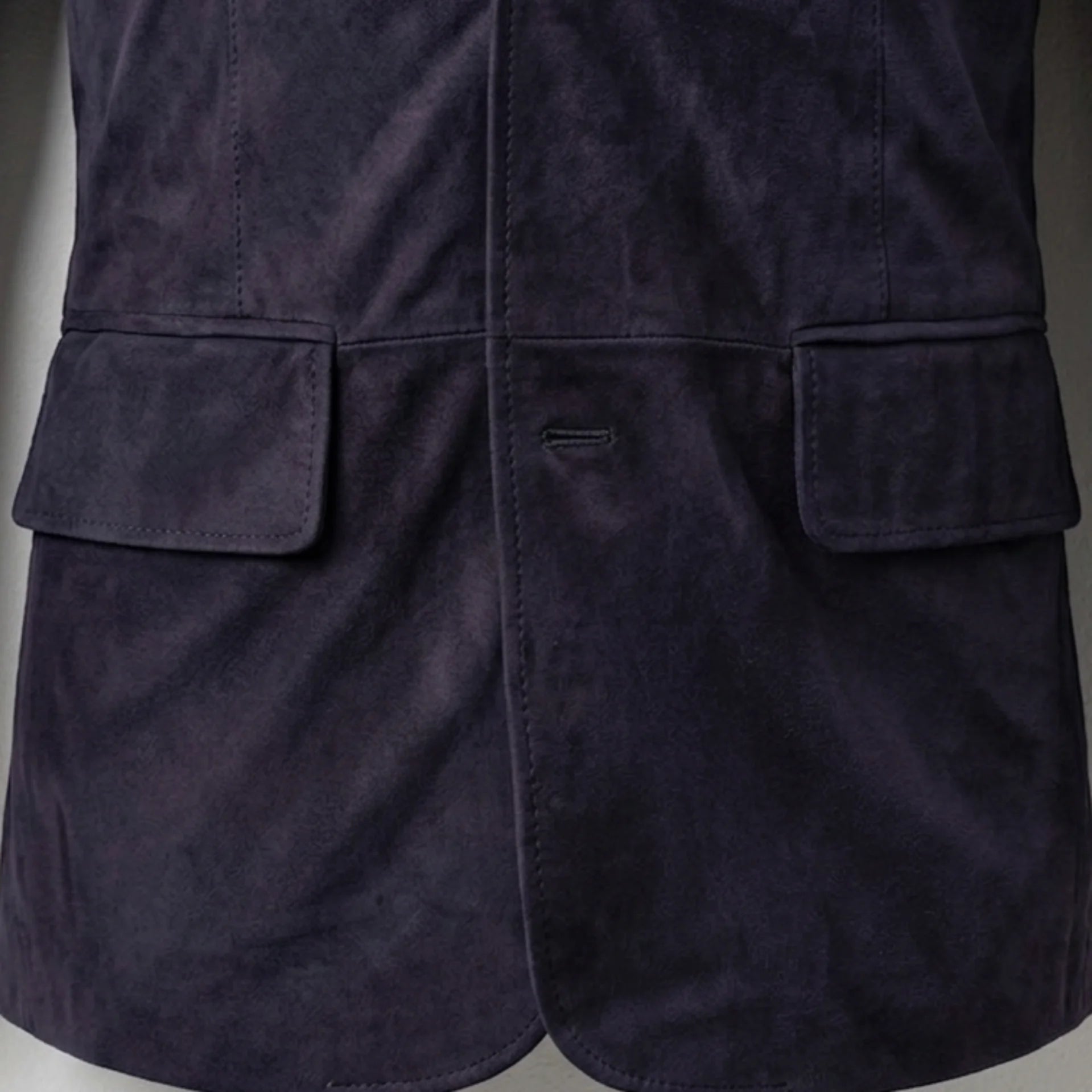 Flap pocket close up on men’s slate purple suede blazer jacket