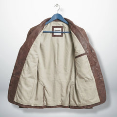 Inside beige lining of men’s distressed brown leather blazer jacket