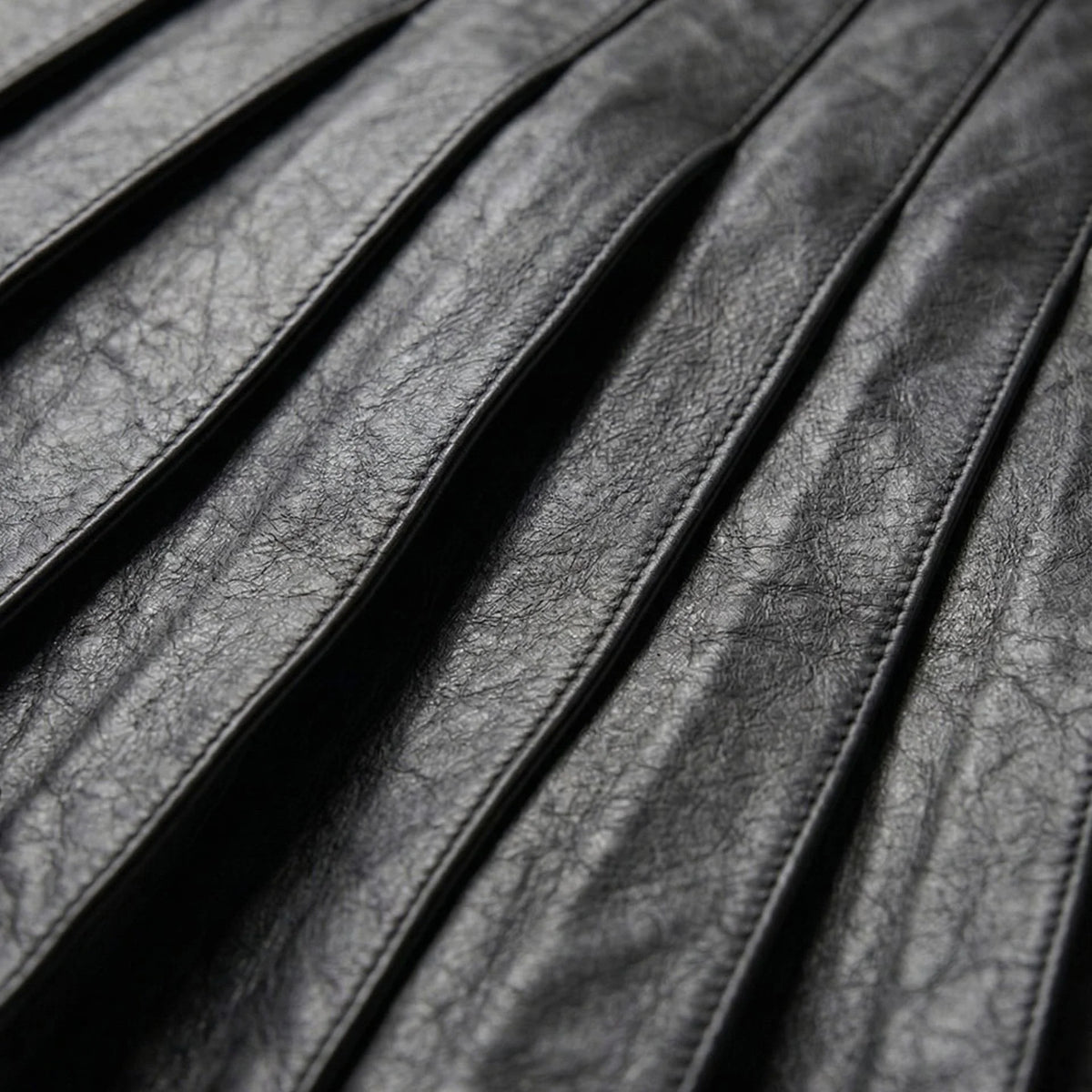 Detail of pleated black leather panels on gothic kilt