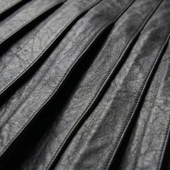 Detail of pleated black leather panels on gothic kilt