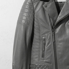 detail of ribbed side panel and zipper pocket on men's grey quilted moto jacket.