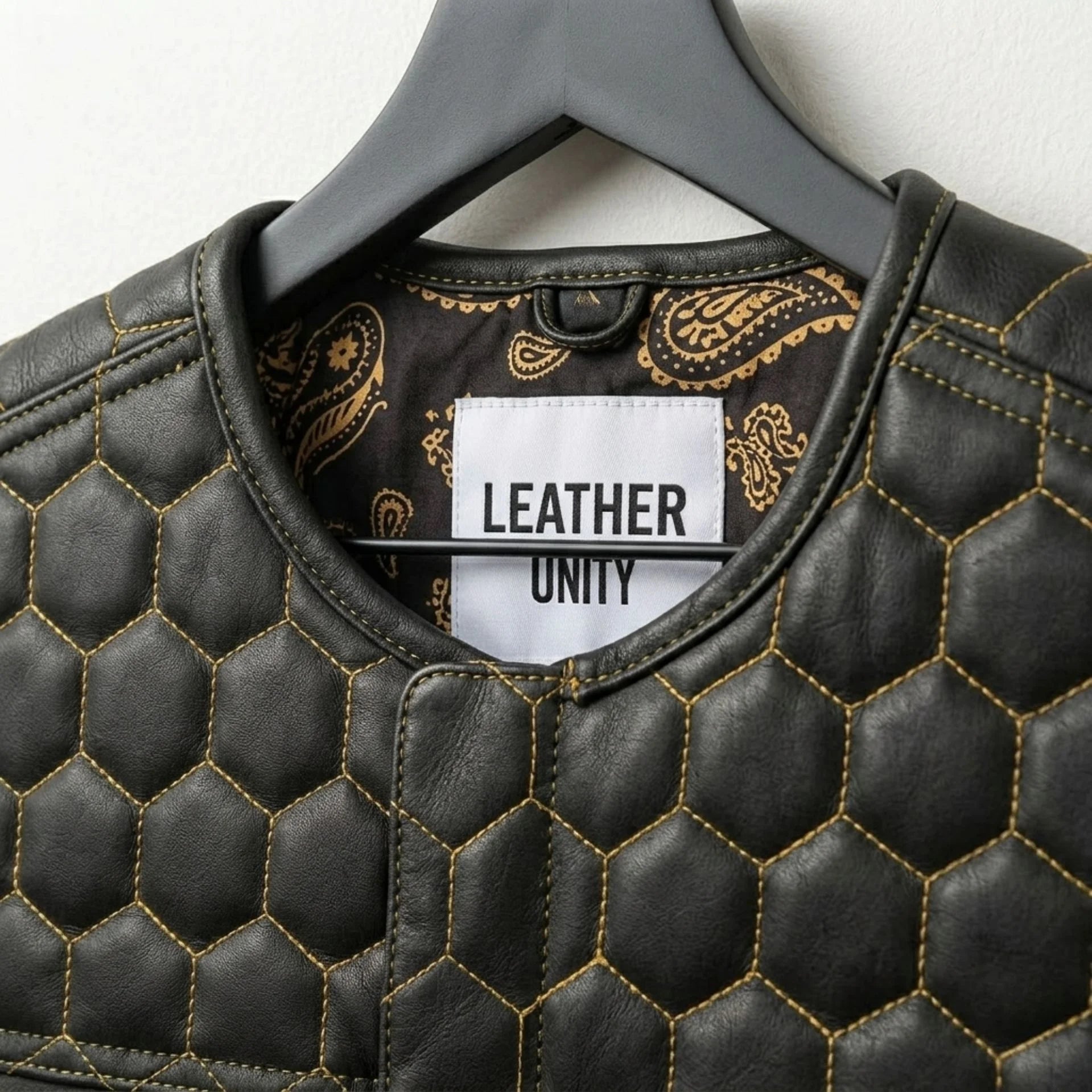 Close-up of honeycomb quilting and Leather Unit label on black leather vest