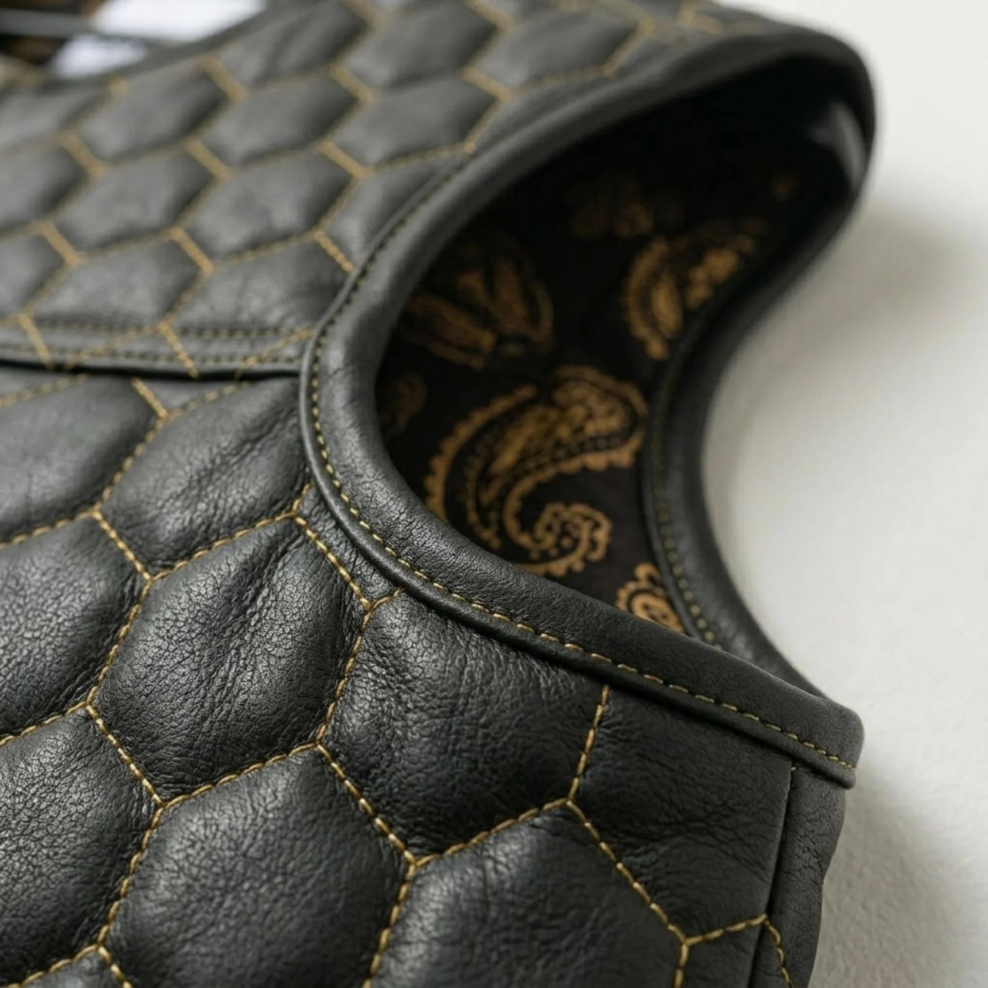 Detail of quilted shoulder and paisley lining on men's honeycomb leather vest
