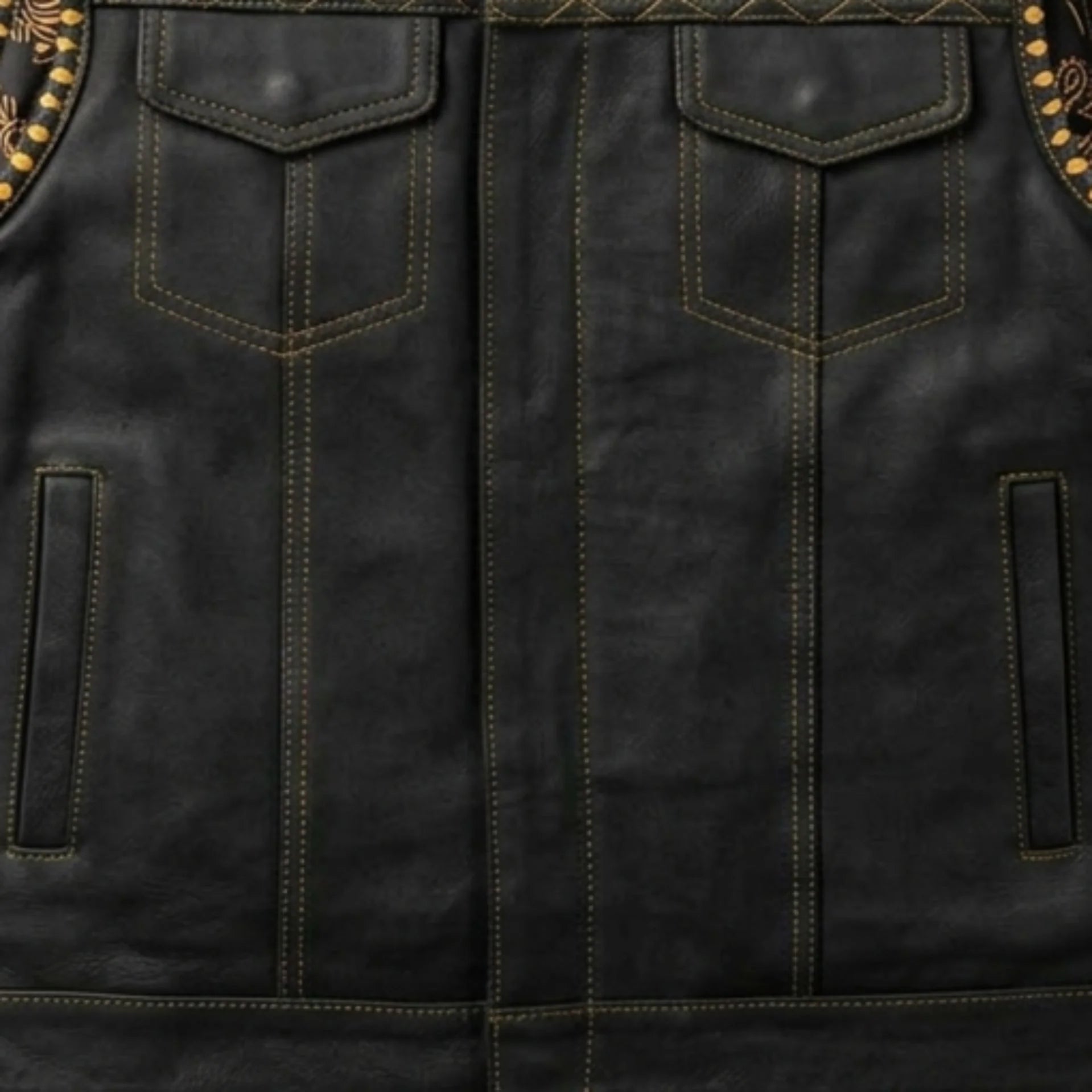 Close-up of chest and hand pockets with contrast stitching on men's black biker vest