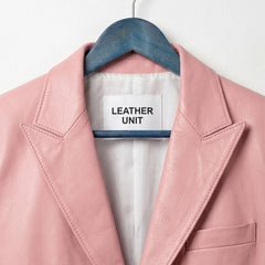 Close up of notch lapel and Leather Unit label on light pink blazer