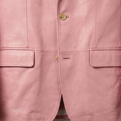 Flap pocket and front button close up on men’s pastel pink leather blazer