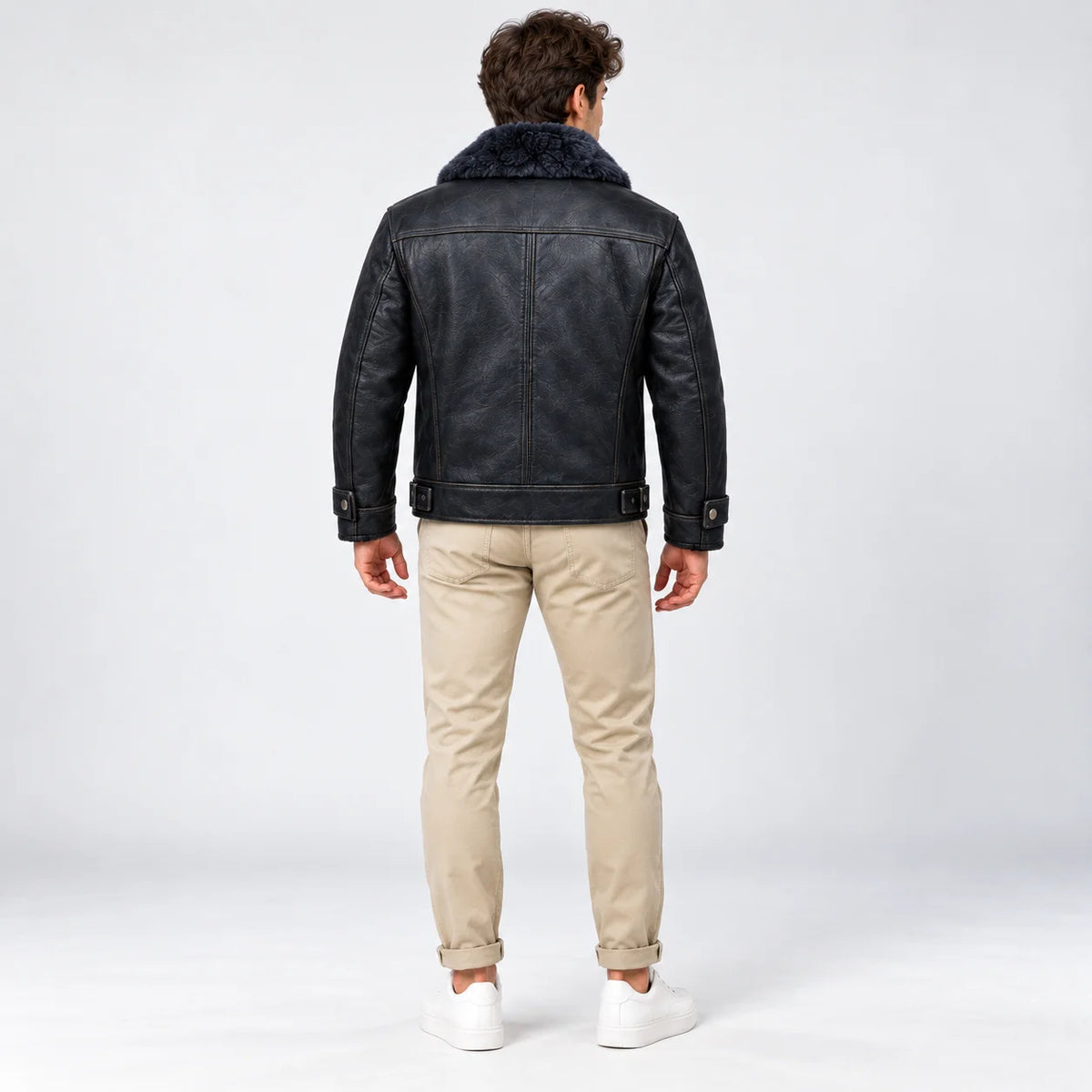 Rear model view of midnight navy leather aviator jacket showing shoulder yoke, centre seam and waist tabs