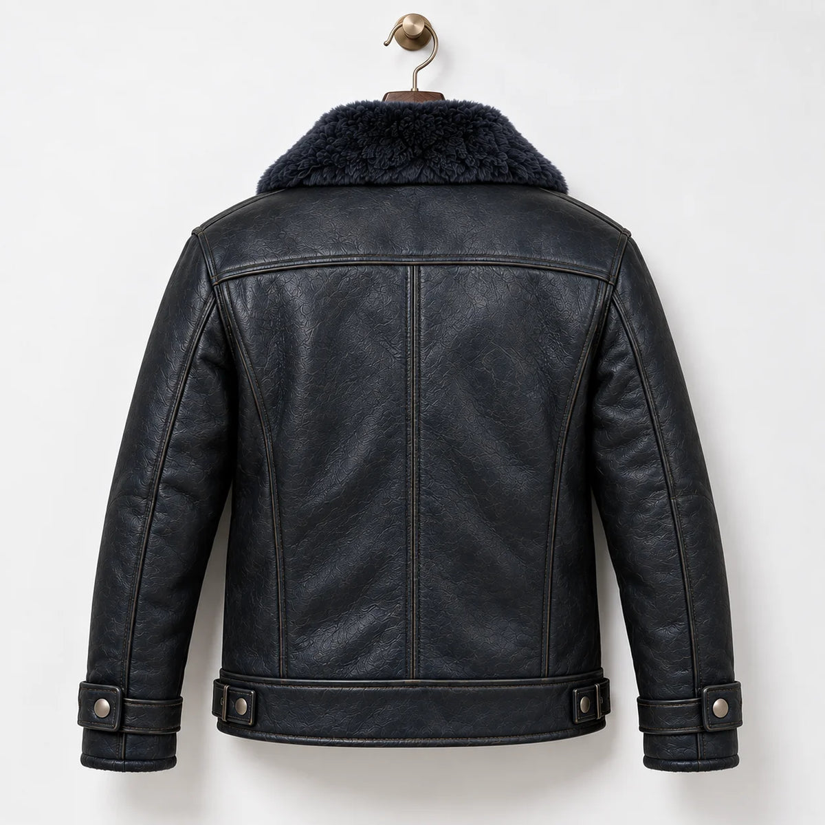 Back hanger view of navy leather flight jacket showing natural grain, panel seams and adjustable hem tabs