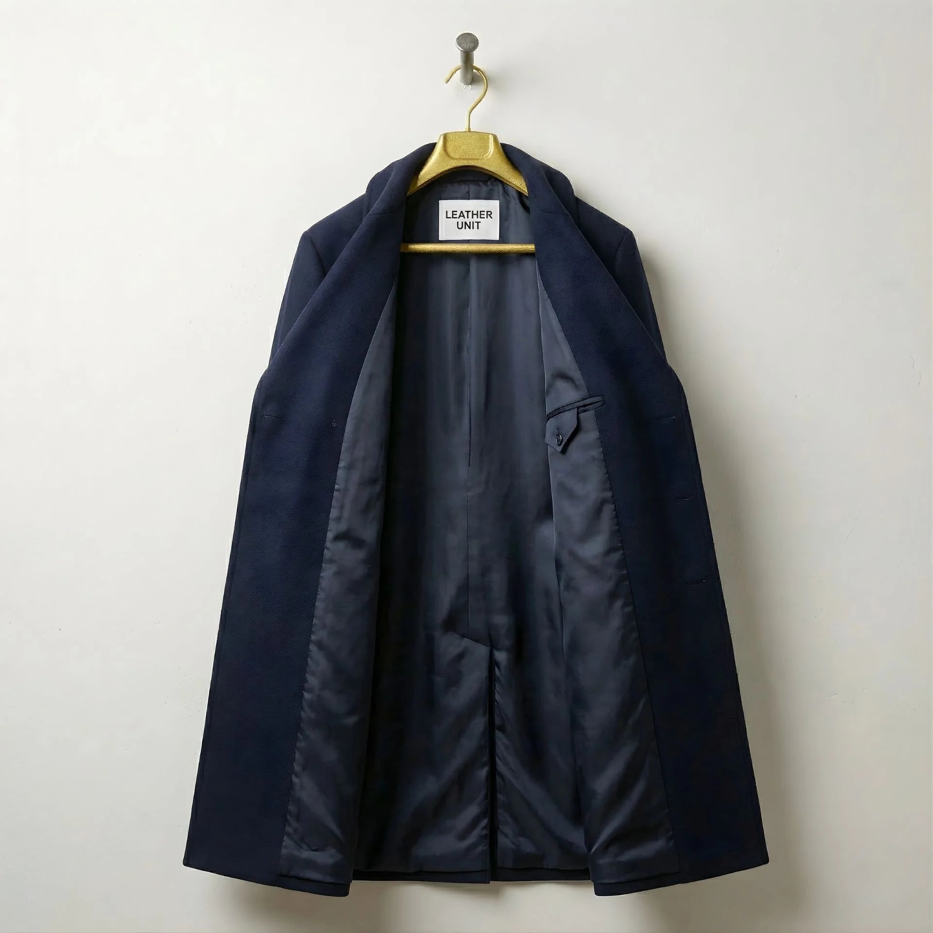 Interior of men's navy wool overcoat showing smooth lining and inner pocket.