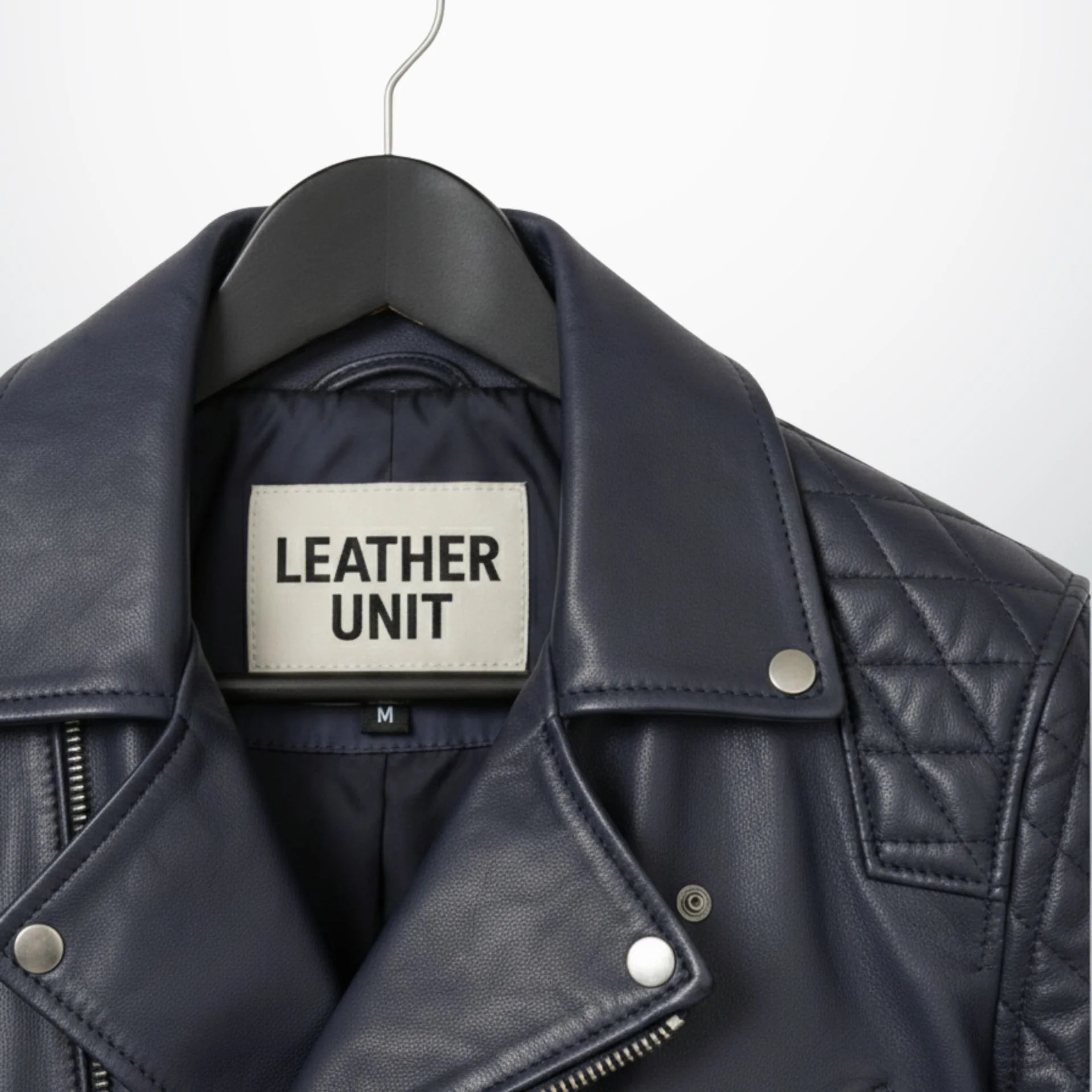 close up of collar and label on men's navy leather biker jacket.