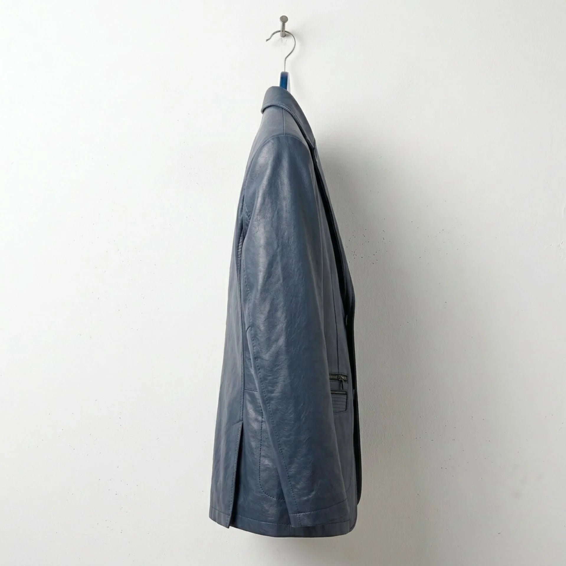 Side profile of men's navy leather blazer jacket with slim tailored fit.
