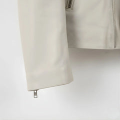 sleeve and cuff zipper close up on men's off white leather biker jacket.