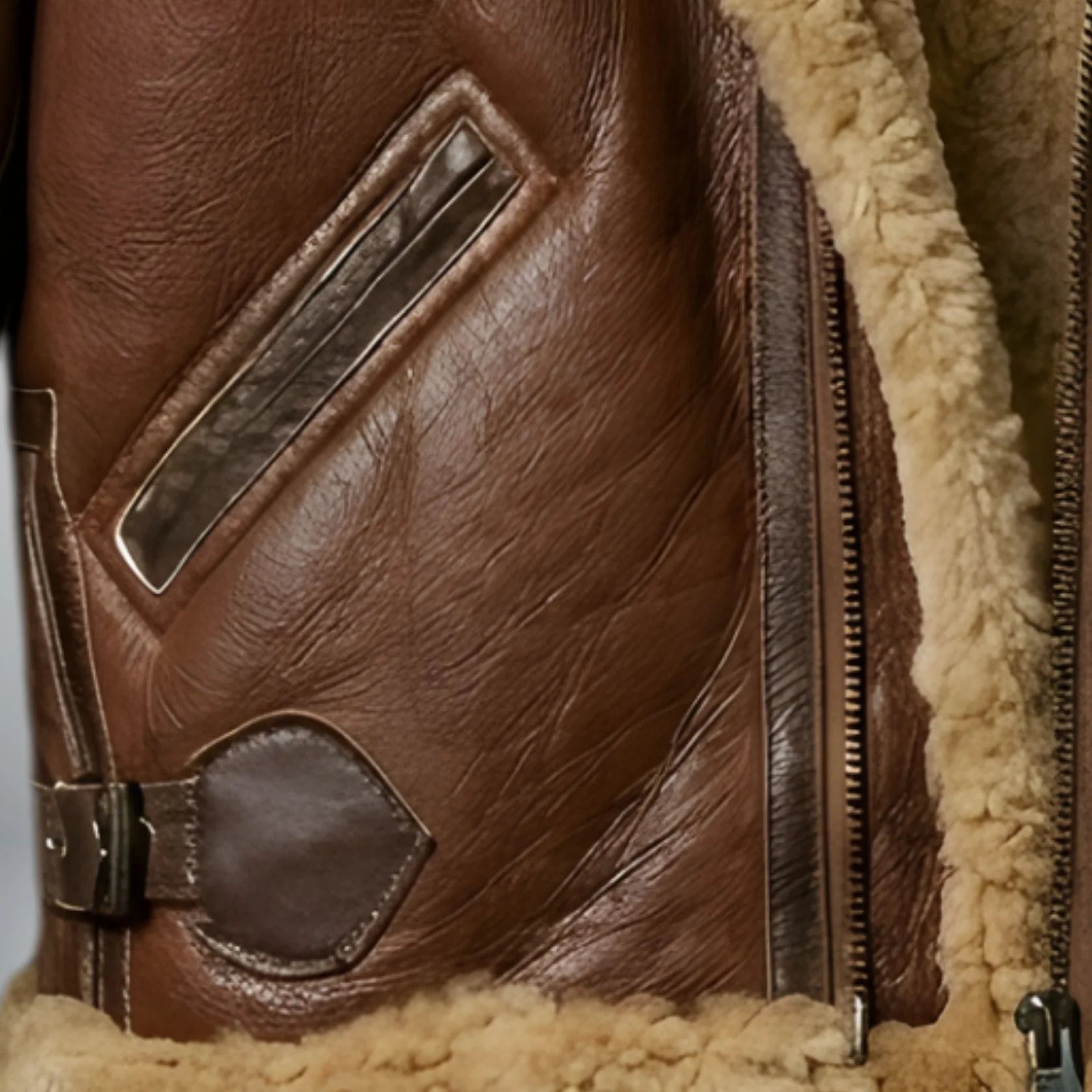 close up slanted hand pocket and leather grain on mens b3 bomber jacket.