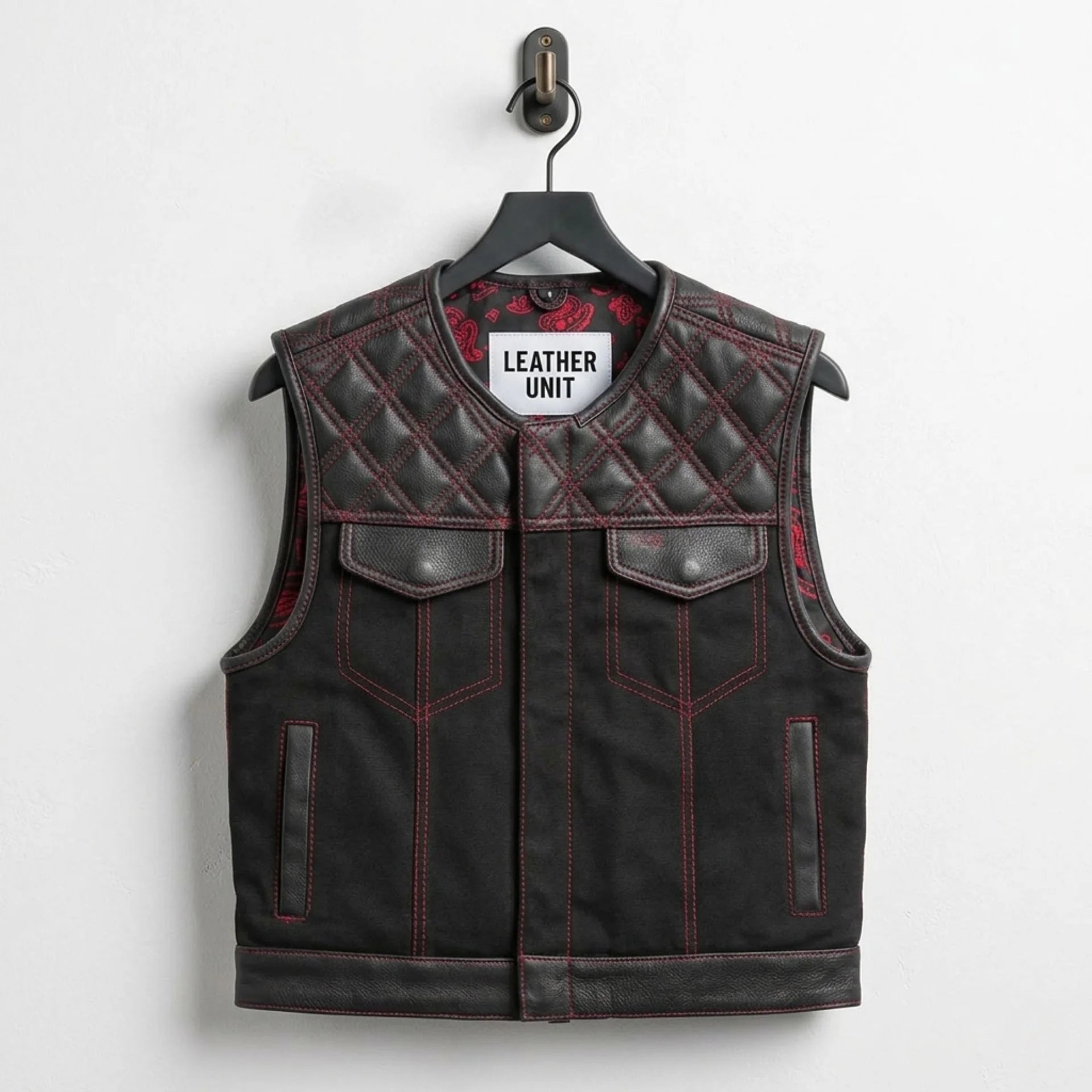 Front view of men's black quilted leather biker vest with red stitching by Leather Unit