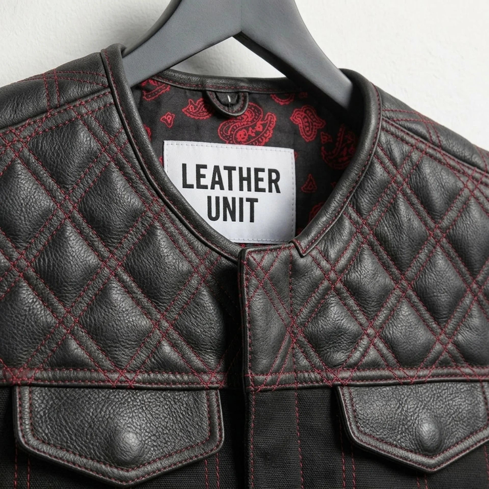 Close-up of collar, Leather Unit label and diamond quilted shoulders on black leather vest