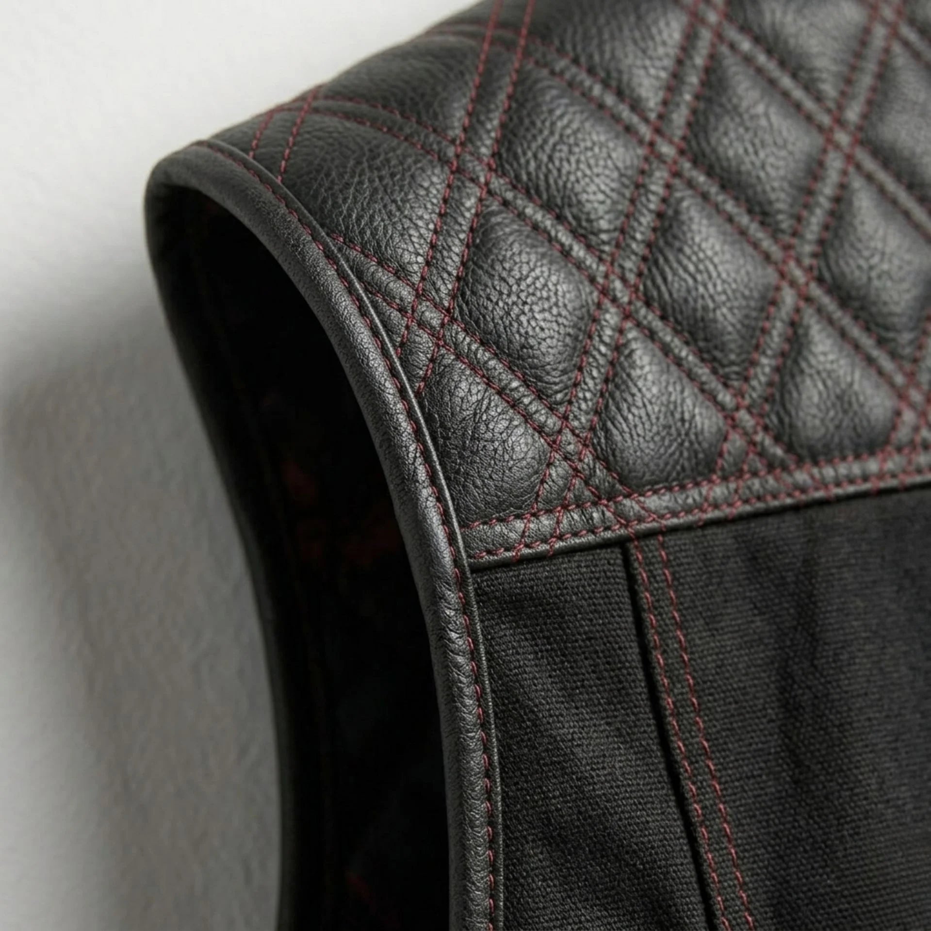 Detail of quilted leather shoulder and armhole binding on men's biker vest