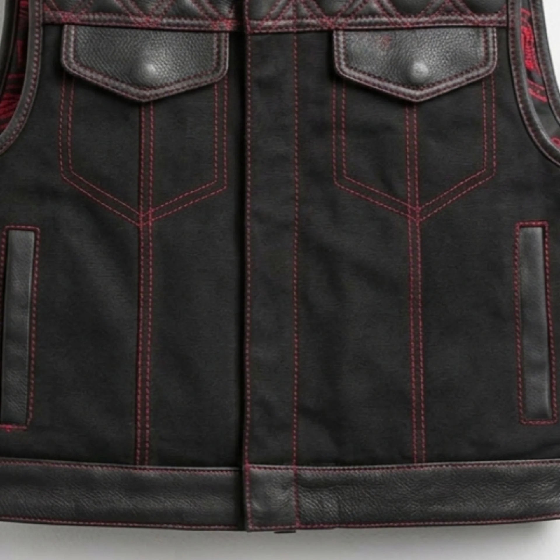 Close-up of front pockets, red stitching and leather hem on men's quilted leather vest
