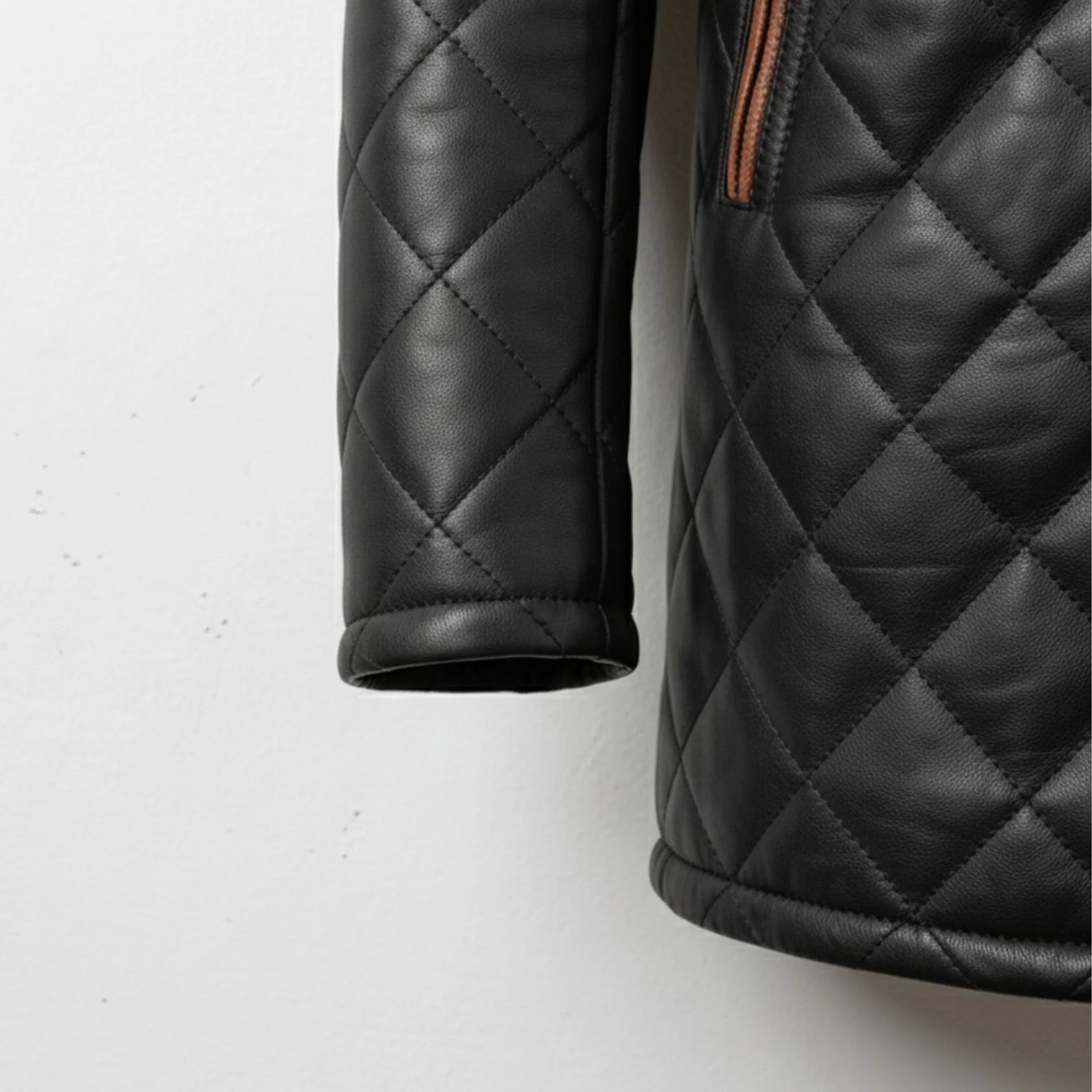 Sleeve and cuff detail on men’s black diamond quilted leather jacket