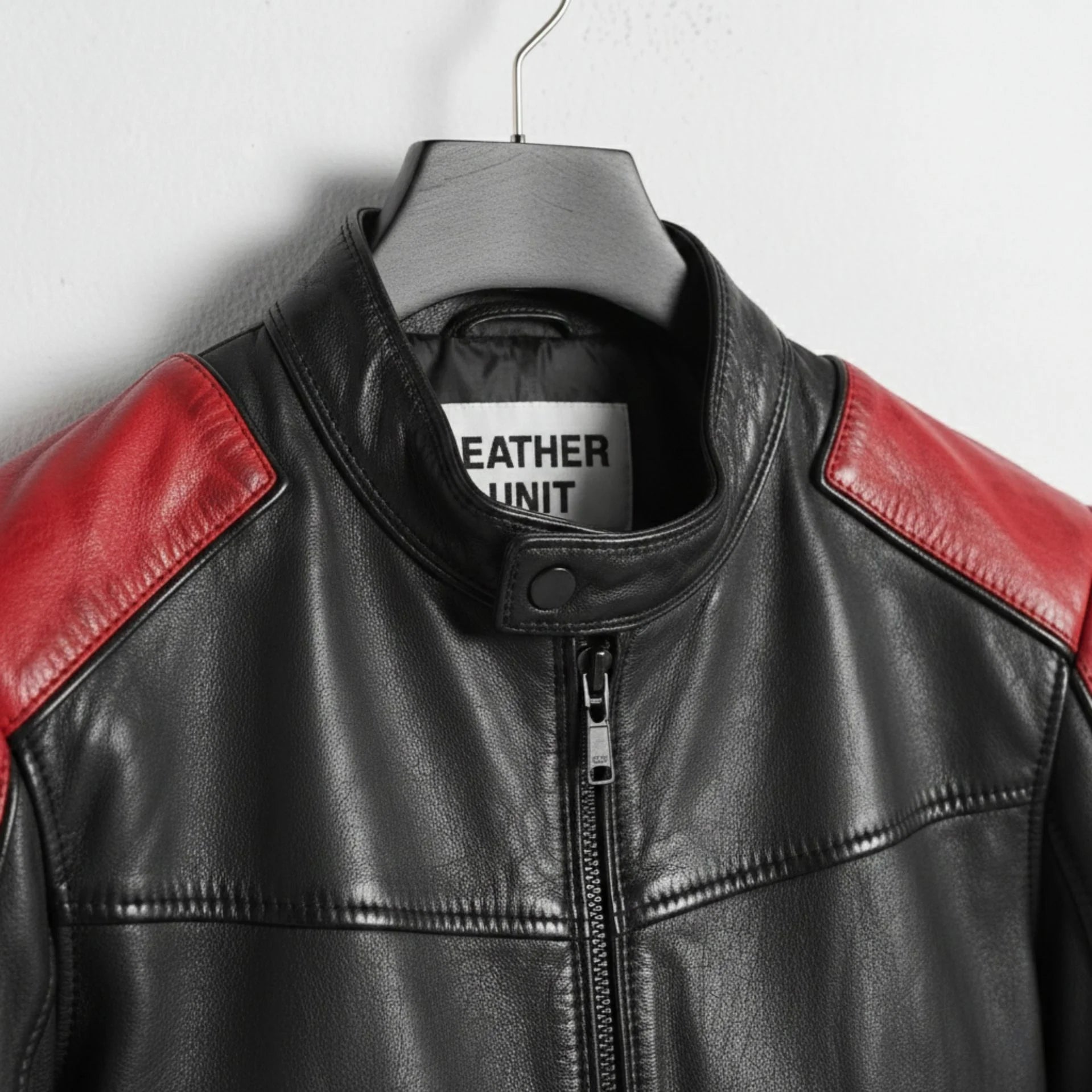 close up of collar and zipper on men's red and black leather moto jacket.