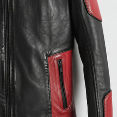 detail of red pocket panel and zipper on men's black leather biker jacket.