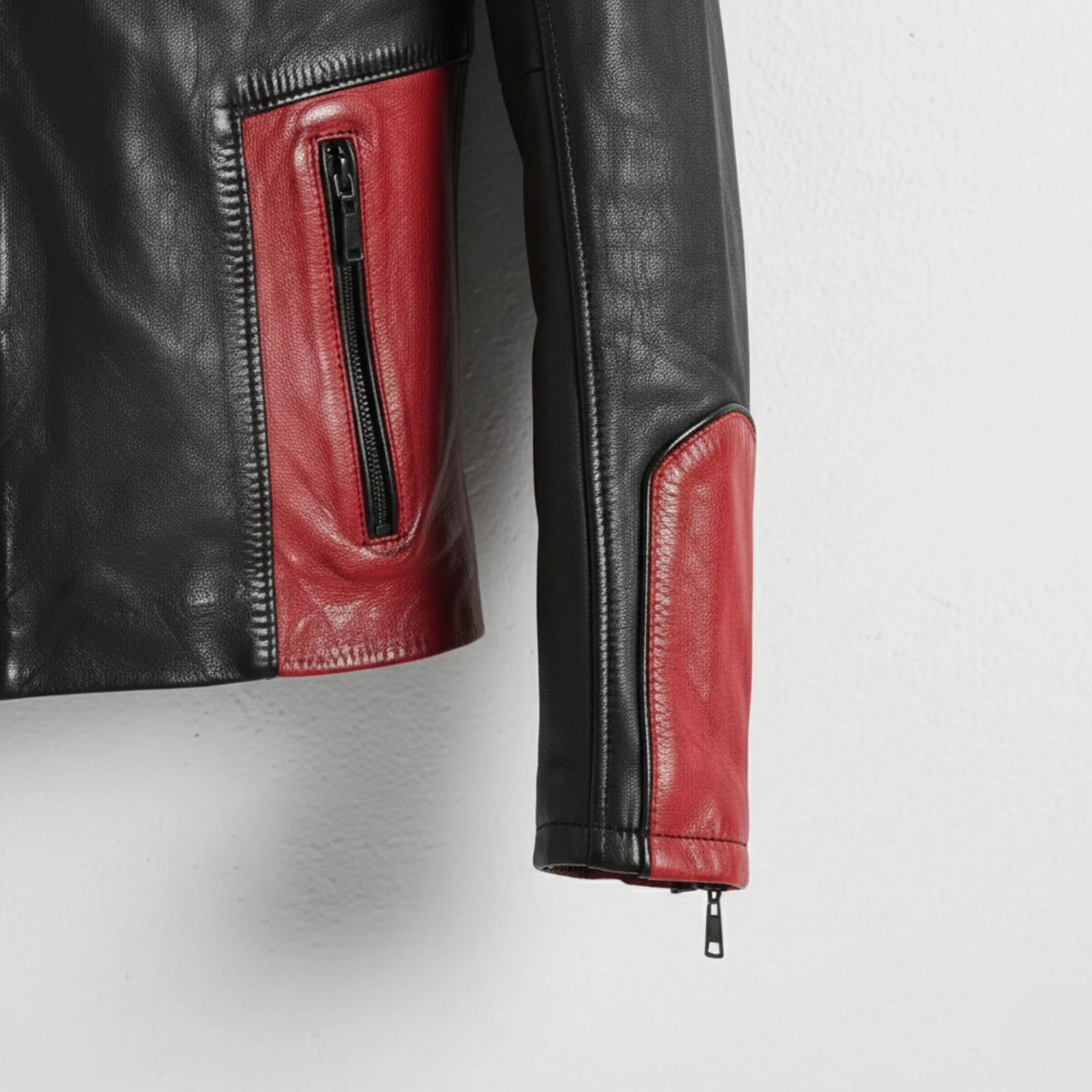 sleeve and cuff zipper detail on men's red and black leather motorcycle jacket.