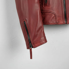 sleeve and cuff zipper close up on men's red leather motorcycle jacket.