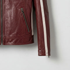 Detail of sleeve stripe and zip pocket on men's red cafe racer jacket.