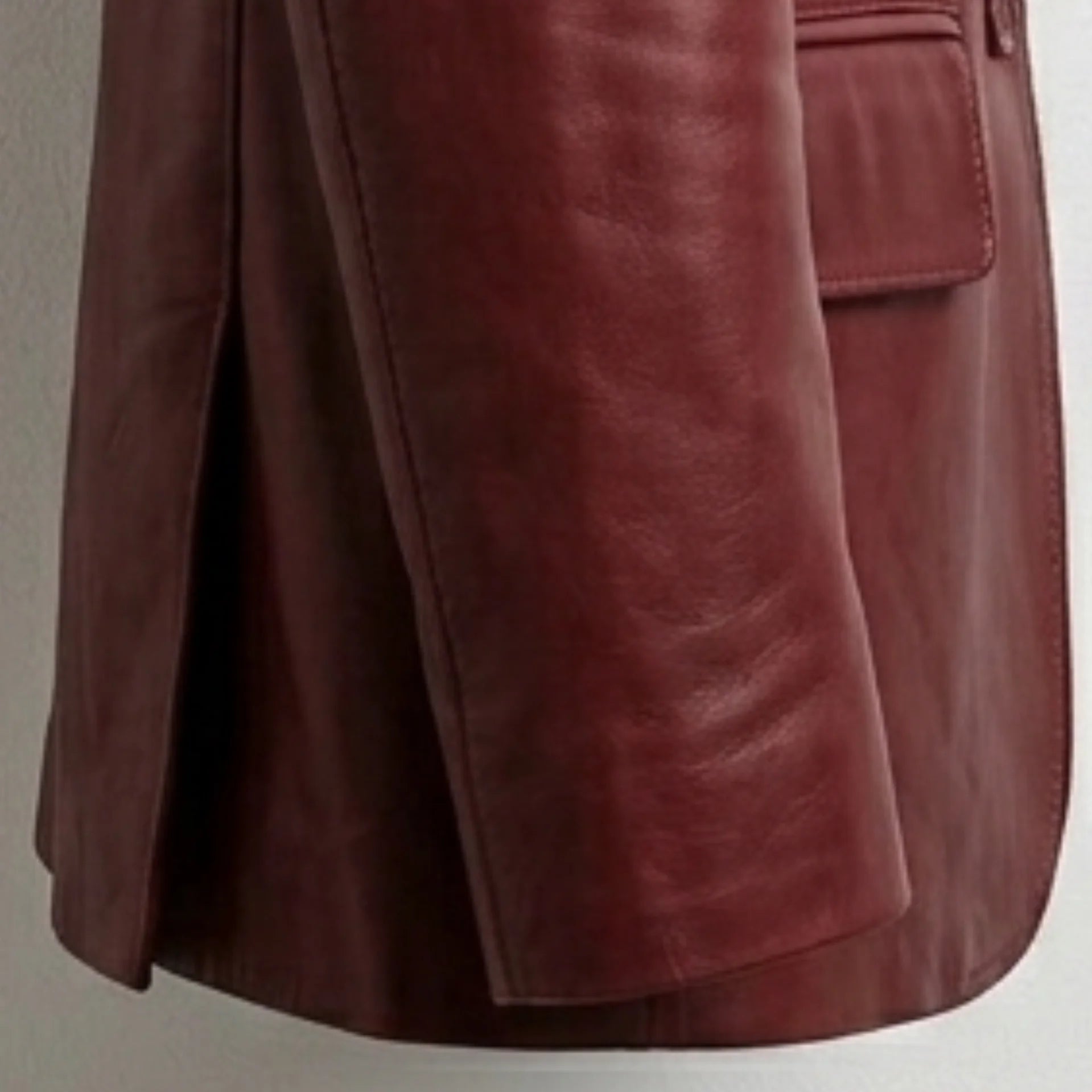 Rear vent and hem detail on men’s red leather sport coat