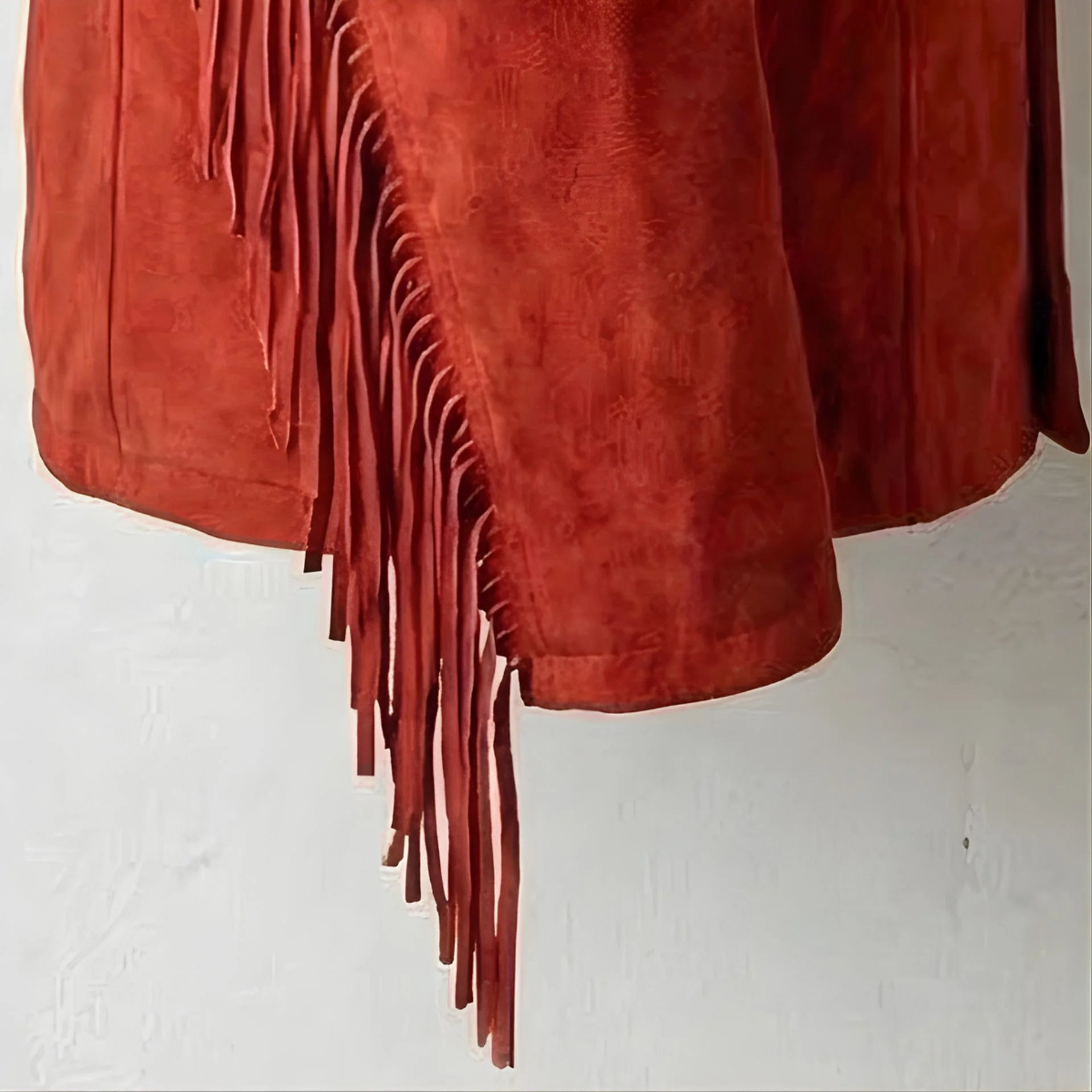 Detail of long side fringe on red suede western jacket.