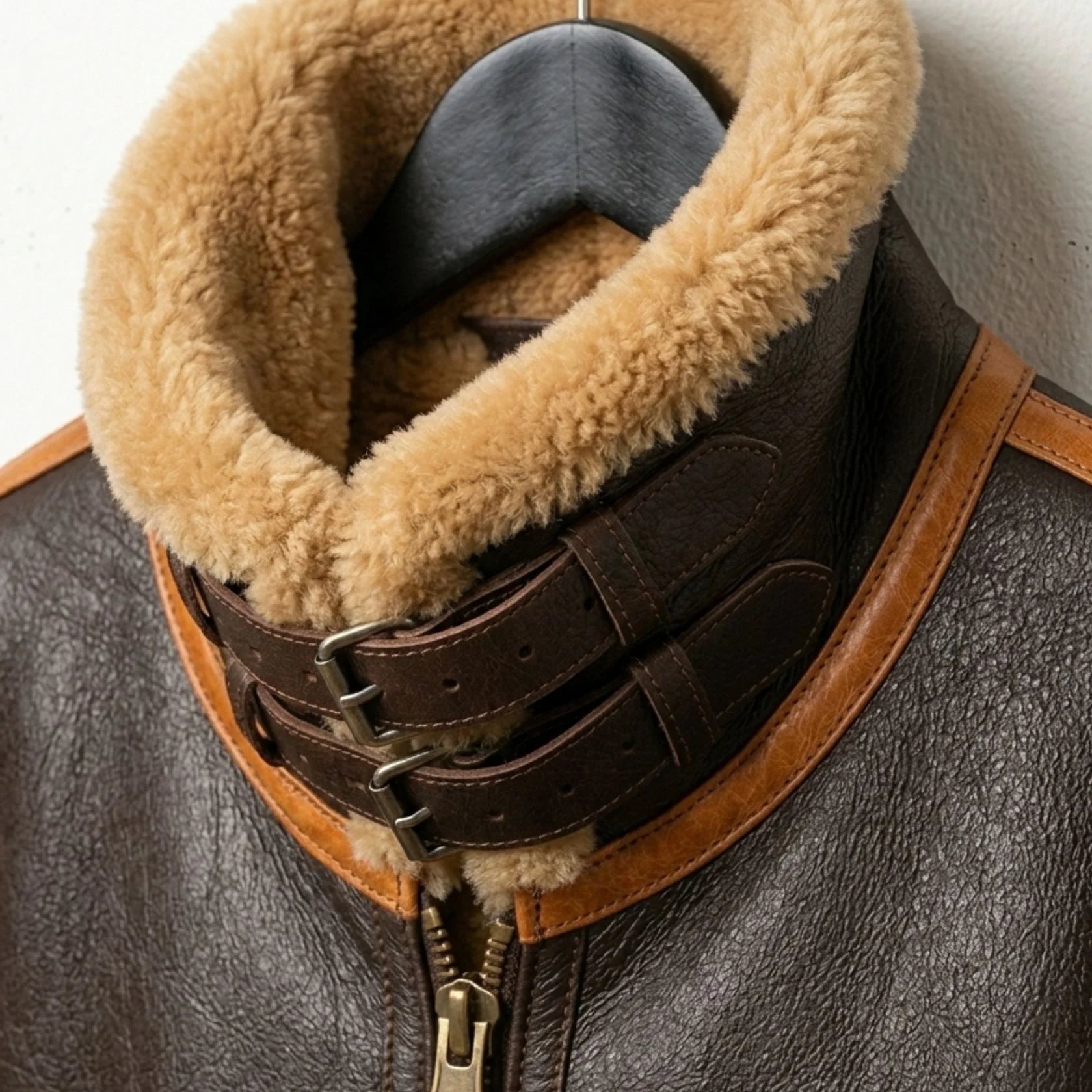 close up fold down collar and button strap on mens aviator leather jacket.