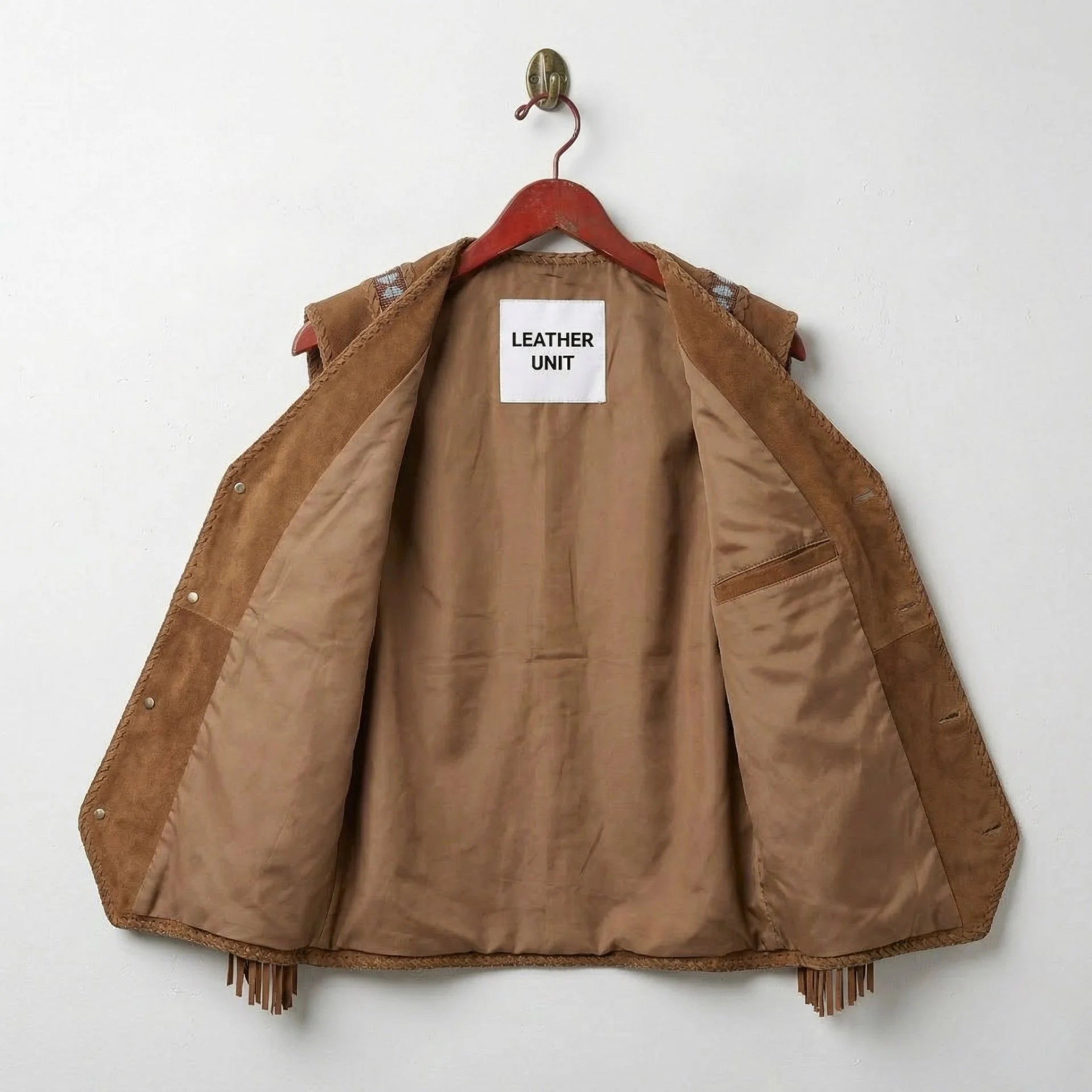 Interior of men's suede western vest showing smooth brown lining and inside pocket.