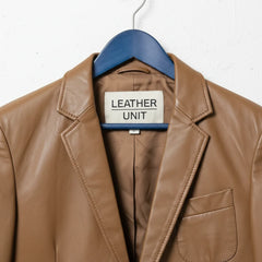 Close up of lapel collar and Leather Unit label on brown leather blazer