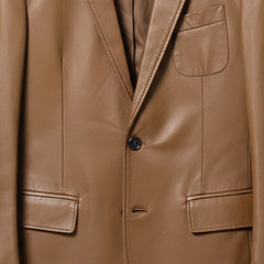 Front buttons and flap pockets on men’s brown leather sport coat